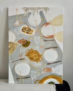 a painting on a wall with plates and candles