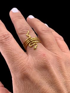 Adjustable Stainless steel gold ring. It doesn't change color with use. very resistant to erosion. USA size 6-7.5 Adjustable Gold Snake-shaped Jewelry, Gold Open Snake Ring, Elegant Gold Snake Ring In Brass, Elegant Gold Brass Snake Ring, Gold 14k Open Snake Ring, Yellow Gold Brass Snake Ring As Gift, Yellow Gold Brass Snake Ring For Gift, Elegant Gold Snake Ring, Adjustable 14k Gold Snake Ring