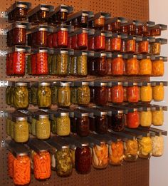 many jars of pickles and vegetables are on the wall