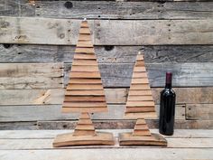 two wooden christmas trees and a bottle of wine