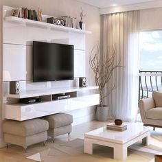 a living room filled with furniture and a flat screen tv on top of a wall