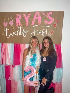 two women standing next to each other in front of a sign that says drya's twenty first