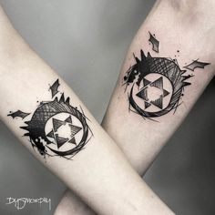 two people with matching tattoos on their arms, one is holding the other's arm