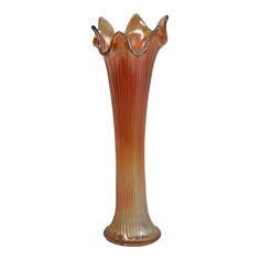 a tall glass vase sitting on top of a table