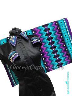 a woman's black dress with purple, blue and green designs on the collar