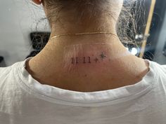 a woman with a small tattoo on her neck