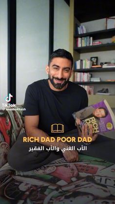 a man sitting on top of a couch next to a pile of books with the caption rich dad poor dad