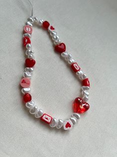 a red and white beaded necklace with hearts