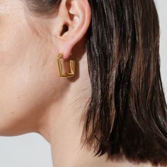 The much-loved classic hoops get an edgy upgrade with these folded rectangular hoop earrings, an ode to simplistic style statements using deconstructed geometry. Slim posts give this subversive-basic design effortless wearability, perfect for your newest Ear Party look.

Size: 24.5x22mm
Material: 18k Gold Plated On Brass Simplistic Style, Ear Party, Open Hoop Earrings, Basic Design, Party Look, Earrings In Gold, Party Looks, Geometry, 18k Gold