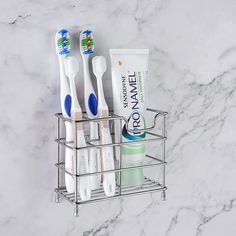 toothbrushes in holder on marble counter top