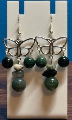 Beautiful moss agate dangle earrings. Made with sterling silver earwire and comes with earring backs. Be sure to check out the matching necklace and bracelet! I take pride in my work so if there are ever any problems with this piece, please let me know so we can get it fixed! I make one of a kind jewelry that will stand out! Will ship Quickly!! Handmade Agate Dangle Jewelry, Spiritual Agate Dangle Jewelry, Unique Agate Jewelry With Matching Earrings, Agate Drop Earrings Gift, Agate Drop Earrings As A Gift, Agate Drop Earrings For Gift, Agate Drop Earrings With Matching Set, Trendy Agate Drop Earrings, Ocean Jasper Round Beads Jewelry As Gift