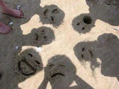 an image of someone's shadow in the sand with their hands and footprints on it