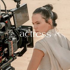 a woman is standing in front of a camera