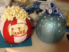 two pumpkins decorated to look like popcorn are sitting on a counter top next to each other