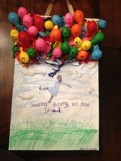 a paper bag with balloons and writing on it that says soaring through two days of school