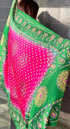 This bright pink and green shawl is beautifully decorated with golden dots and colorful peacock feather designs along the edges. It's light and can be worn in many different ways, perfect for adding a pop of color to any outfit. Great for special events or everyday wear, this shawl brings a touch of Afghan style to your look. Green Shawl, Afghan Style, Colorful Peacock, Feather Design, Peacock Feather, Green And Pink, Shawls And Wraps, Bright Pink, Traditional Style