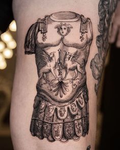 a black and white photo of a woman's tattoo