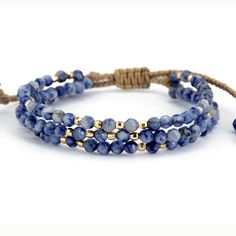 Not only does the Handmade Natural Sodalite and Gold Bead Stack Bracelet look great, it makes the perfect gift for someone. Sodalite brings order and calmness to the mind and is an excellent stone for anyone on the path for truth and discovery. Called the Logic Stone, it inspires awakening, deep thought and helps to clear the mind. It promotes Confidence, Communication and Creativity. It benefits the Throat Chakra with communication and expression of creativity - feeling comfortable to express y Adjustable Lapis Lazuli Beaded Bracelets Bohemian Style, Adjustable Natural Stones Braided Bracelet For Meditation, Adjustable Braided Bracelets With Natural Stones For Meditation, Adjustable Hand-strung Lapis Lazuli Bracelets, Spiritual Healing Braided Bracelets With Gemstone Beads, Blue Natural Stones Friendship Bracelets, Blue Natural Stones Bracelets For Friendship, Blue Natural Stone Bracelets For Friendship, Adjustable Lapis Lazuli Beaded Bracelets