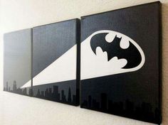 two black and white paintings on the wall with batman logos painted on each one side