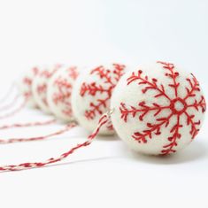 red and white snowflake ornaments are lined up