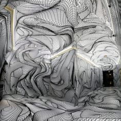 the interior of an art installation with lines and curves on it's walls, as seen from above