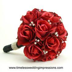 a bridal bouquet with red roses and crystals