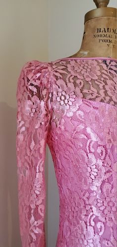 Absolutely pristine vintage 1960's Pink Satin Mermaid Dress with Lace Overlay! This piece is unique in so many ways & I can honestly say I've never seen anything like her. The color is will stop you in your tracks! Vibrant doesn't even being to describe the saturation of the pink in the satin & lace. The dress can be worn with or without the lace overlay - 2 dresses in 1! The dress is made of a silky satin fabric that transitions into a matching lace mermaid skirt that is cut in the high low silhouette. Featuring delicate spaghetti straps, v neck / sweetheart neckline, & vintage Talon zipper down the center back. The lace overlay completes the lace detailing by connecting with the lace mermaid skirt for a full lace look! The lace overlay attaches with hook and threaded eye closures down th Pink Vintage Dress For Party, Fitted Vintage Lace Dress With Long Sleeves, Long Sleeve Lace Vintage Dress For Party, Long Sleeve Lace Vintage Party Dress, Vintage Pink Dress With Fitted Bodice For Party, Pink Vintage Dress With Fitted Bodice For Party, Retro Vintage Long Sleeve Dress For Party, Retro Long Sleeve Vintage Dress For Party, Retro Lace Vintage Dress For Party