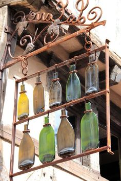 several bottles are hanging from the side of a building