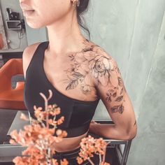 a woman with flowers on her chest and arm