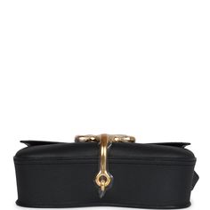 This Della Cavalleria Elan is of Black Epsom leather with gold hardware, features tonal stitching, rectangular shaped bag with curved base, gold half-bit clasp closure, a flat leather buckle shoulder/crossbody strap with one exterior back pocket. The interior is lined in Black swift leather and has one interior slip pocket on back wall.Collection: WOrigin: FranceCondition: New and never worn (plastic on hardware)Accompanied by: Hermes box, Hermes dustbag, felt, and carebookMeasurements: 9" width x 6" height x 2.5" depth; 19" strap drop Gold Shoulder Bag With Turn-lock For Work, Gold Shoulder Bag With Turn-lock Closure For Work, Chic Business Saddle Bag With Gold-tone Hardware, Rectangular Leather Bag With Horsebit Detail, Elegant Gold Shoulder Bag With Horsebit Detail, Elegant Workwear Saddle Bag With Turn-lock Closure, Leather Business Bags With Horsebit Detail, Elegant Workwear Saddle Bag With Metal Hardware, Leather Bags With Horsebit Detail