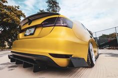 the rear end of a yellow sports car