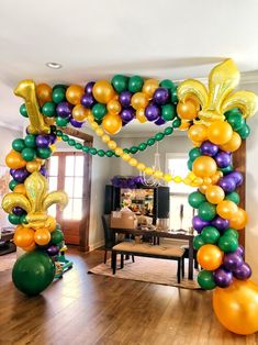 an arch decorated with balloons and streamers for a st patrick's day celebration