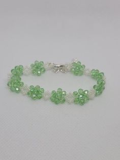 Delicate light green czech crystal bracelet... delicate but durable. This bracelet is so light and easy to wear, you'll forget you have it on.  Suitable for any occasion whether it's everyday wear, or a night out.  4mm green czech rondels 11/0 glass seed beds Lobster clasp Extension chain Elegant May Birthstone Beaded Bracelets With Faceted Beads, Elegant May Birthstone Faceted Beaded Bracelets, Faceted Round Bead Bracelets For May Birthstone, Faceted Round Beads Bracelet For May Birthstone, Adjustable Faceted Bead Bracelets For May Birthstone, Green Crystal Round Beads Bracelets, Green Crystal Beaded Bracelets With Round Beads, Adjustable Bracelet With Faceted Beads, Elegant Adjustable Beaded Crystals