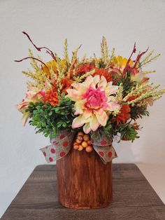 a wooden vase filled with flowers on top of a table