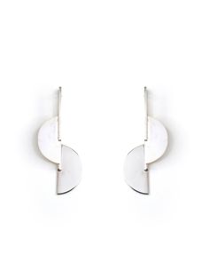 These Half Moon Jacket Earrings by Ami Doshi Shah are made from recycled silver, with contrasting textures adding interest to the minimalist, sculptural shape. Each piece is meticulously handcrafted in Nairobi, Kenya, and meant to become a personal talisman, reminding the wearer to cherish the fleeting moments of life. - Post-back closure for pierced ears- Recycled silver - Created using ethically and sustainably sourced materials- Each piece is made to order and may take up to 2 weeks to comple Modern Crescent Sterling Silver Earrings, Modern Silver Crescent Earrings, Moon Jacket, African Luxury, Contrasting Textures, Moments Of Life, Jacket Earrings, Nairobi Kenya, Pure Form