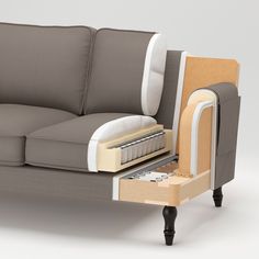 a couch with an open drawer on the back and bottom part in front of it