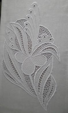 a white piece of cloth with an intricate design on it