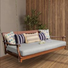 What could be more serene than a Wooden Swing Daybed? Enjoy indoor space for relaxation on a Hanging Swing Daybed with its big size that can fit up to two persons. This version boasts a timeless slatted back, two gently curved arms, and a sturdy mahogany wood frame in a natural brown tone. It comes complete with a polyester cushion filled with foam, fastened to the backrest seat for luxurious comfort. Steel chains for installation are provided. Additionally, the water-based weather-resistant ... Spanish Cottage, Room Swing, Hanging Daybed, Porch Bed, Dnevna Soba, Porch Swing Bed, Indoor Swing, Wooden Swing, Patio Swing