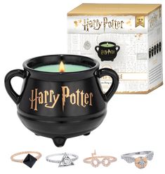 a harry potter tea light candle holder in front of a harry potter ring box and several rings around it