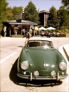 a green car parked in front of a building