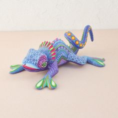 a brightly colored lizard figurine sitting on top of a table