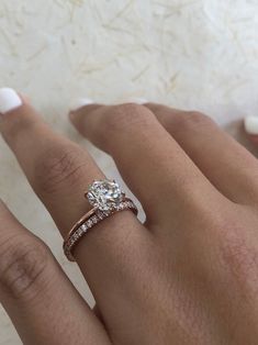 a woman's hand with a diamond ring on it