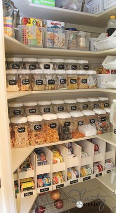 an organized pantry with lots of food and containers on the shelves, including plastic bins