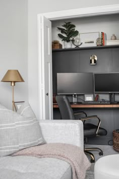 a living room filled with furniture and a computer desk