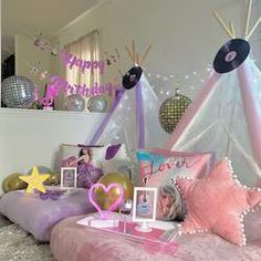 a bed with pink and purple decorations on it