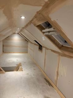 an empty attic with unfinished walls and floor