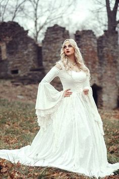 a woman in a white dress is posing for the camera with her hands on her hips