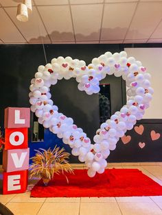 a large heart shaped balloon in the middle of a room