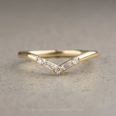 a gold ring with three diamonds on it