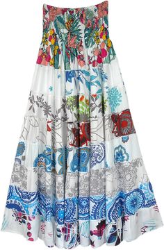 A serene white classy skirt with mixed floral and ethnic prints with a soft smocking waist.  This is a two-in-one skirt and a dress. #tlb #TieredSkirt #vacationclothing #beachwrap #Floral #Printed #Tieredskirt #Smockedskirt #Rayonskirt #Skirtdress White Floral Print Tiered Skirt, Spring Floral Patchwork Maxi Skirt, White Flowy Maxi Skirt With Floral Print, White Flowy Floral Print Maxi Skirt, White Bohemian Dress With Gathered Skirt, White Bohemian Tiered Skirt, Bohemian White Maxi Skirt With Gathered Detail, Bohemian White Gathered Maxi Skirt, Bohemian White Tiered Skirt